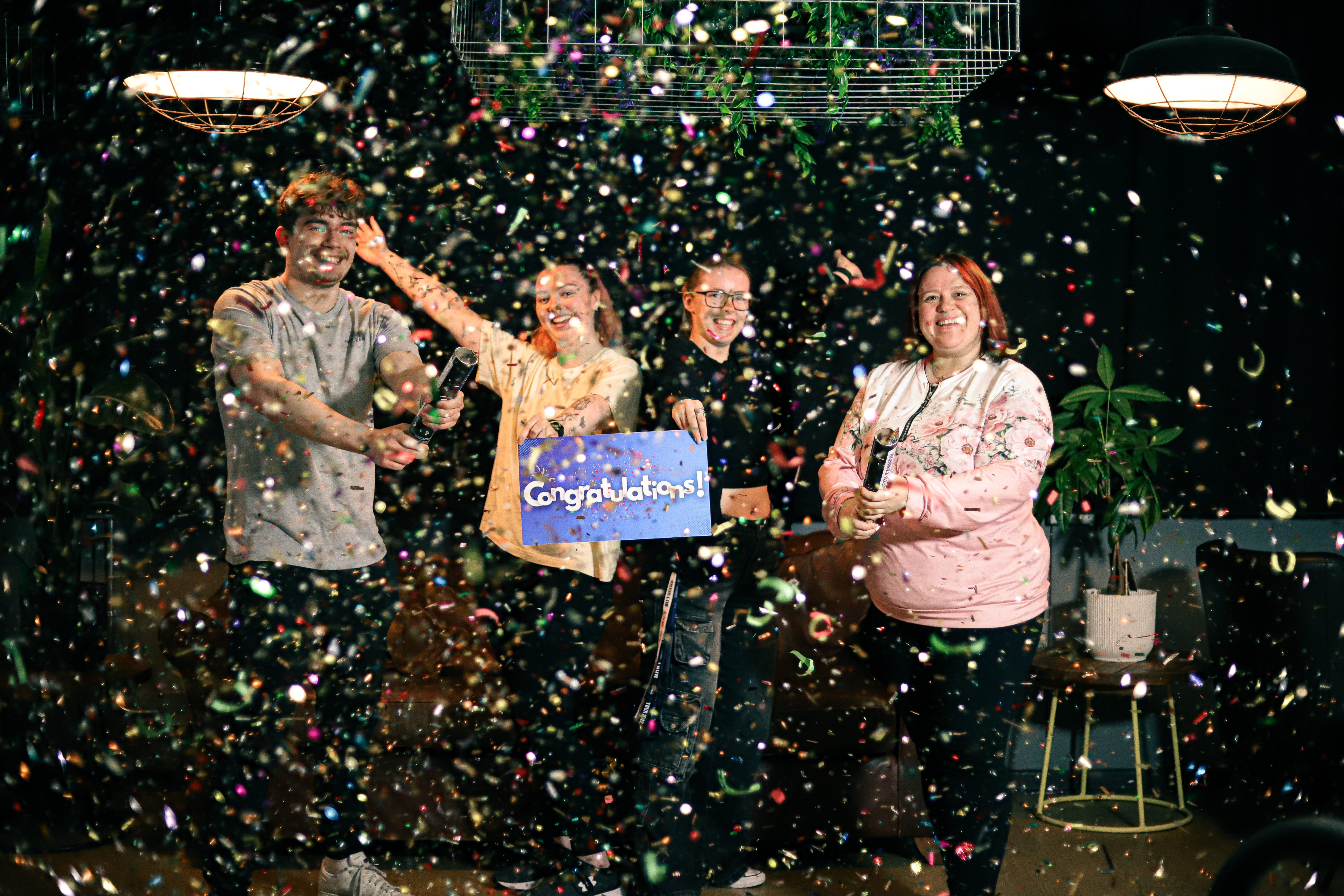 Elected officers in a group smiling as confetti falls around them