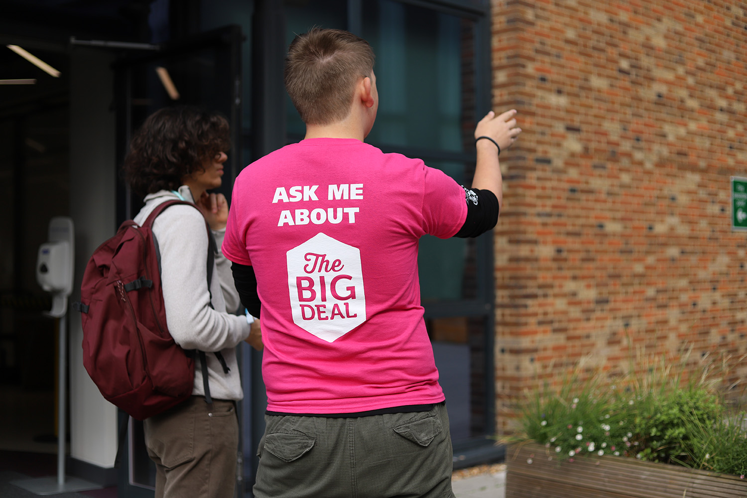 A helpful staff member directing someone.