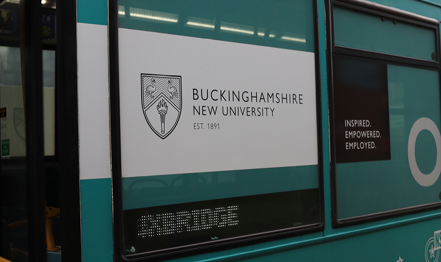 The side of a bus, displaying the BNU logo.